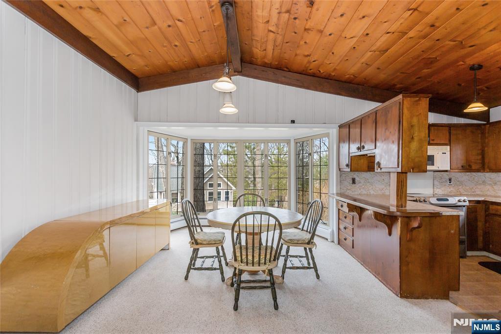 6 Partridge Trail Butler, NJ 07405 - Photo 9 of 37 a living room with furniture a flat screen tv and a floor to ceiling window
