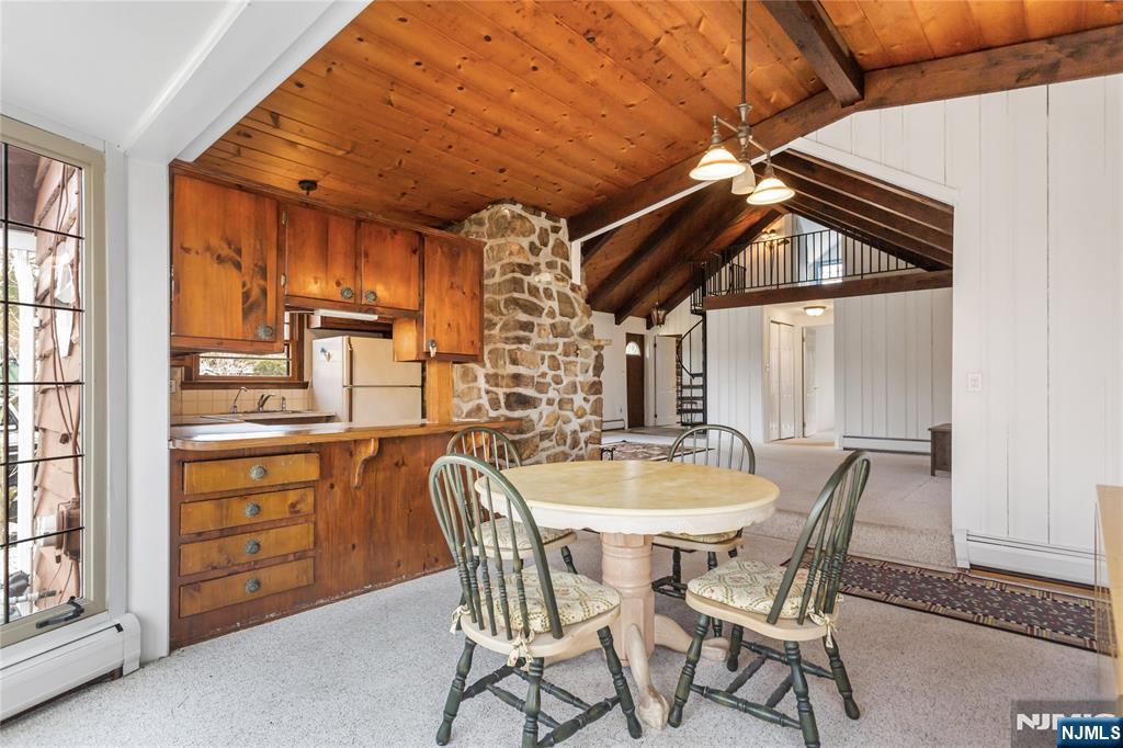 6 Partridge Trail Butler, NJ 07405 - Photo 10 of 37 a dining room with a wooden table and chairs