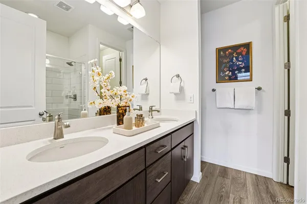 a bathroom with a double vanity sink and a mirror