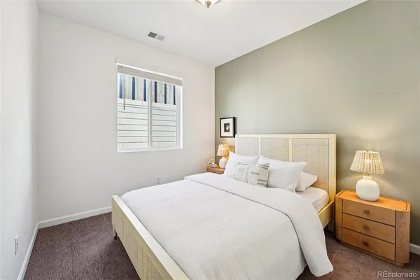 a bedroom with a bed and lamp