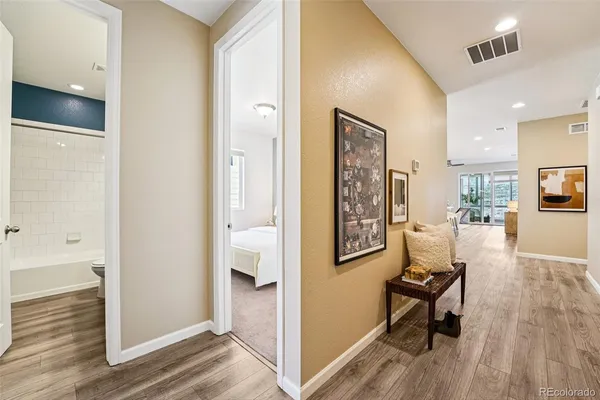 a view of a hallway and dining room with wooden floor