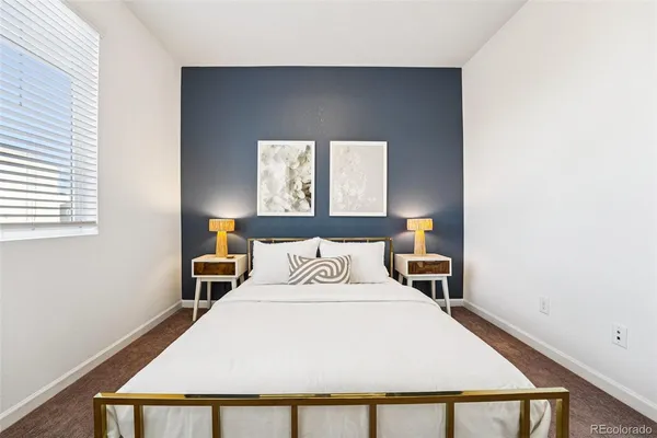 a bedroom with a bed and window