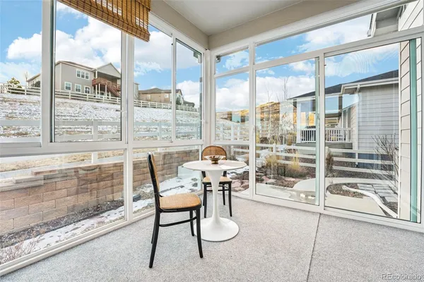 a floor to ceiling window with chairs