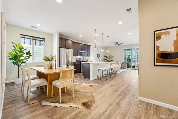 a dining room with furniture and a kitchen view