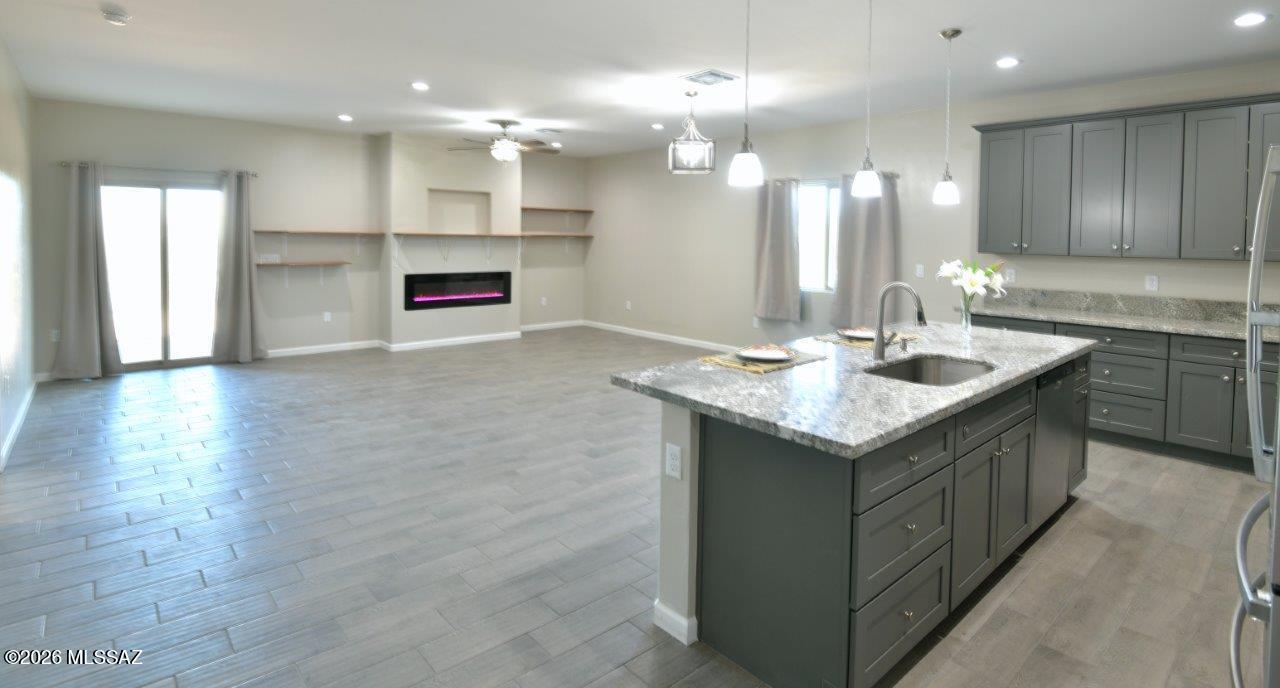 1091 North Vail View Road Vail, AZ 85641 - Photo 7 of 43 a kitchen with kitchen island granite countertop a sink stainless steel appliances and cabinets