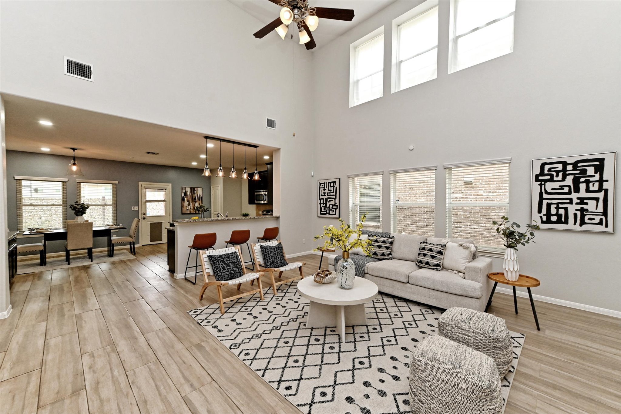 177 Eagle Owl Loop Leander, TX 78641 - Photo 1 of 1 Living room with light wood finished floors, a ceiling fan, and a high ceiling