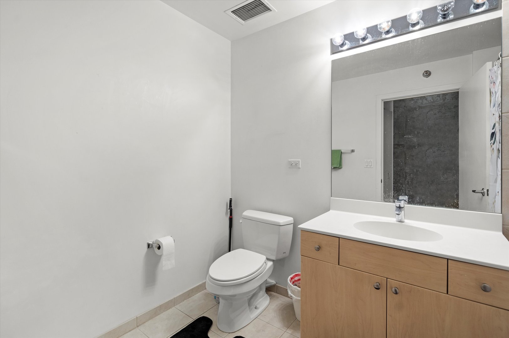 235 West Van Buren Street, Unit 3509 Chicago, IL 60607 - Photo 12 of 19 a bathroom with a sink a toilet and mirror