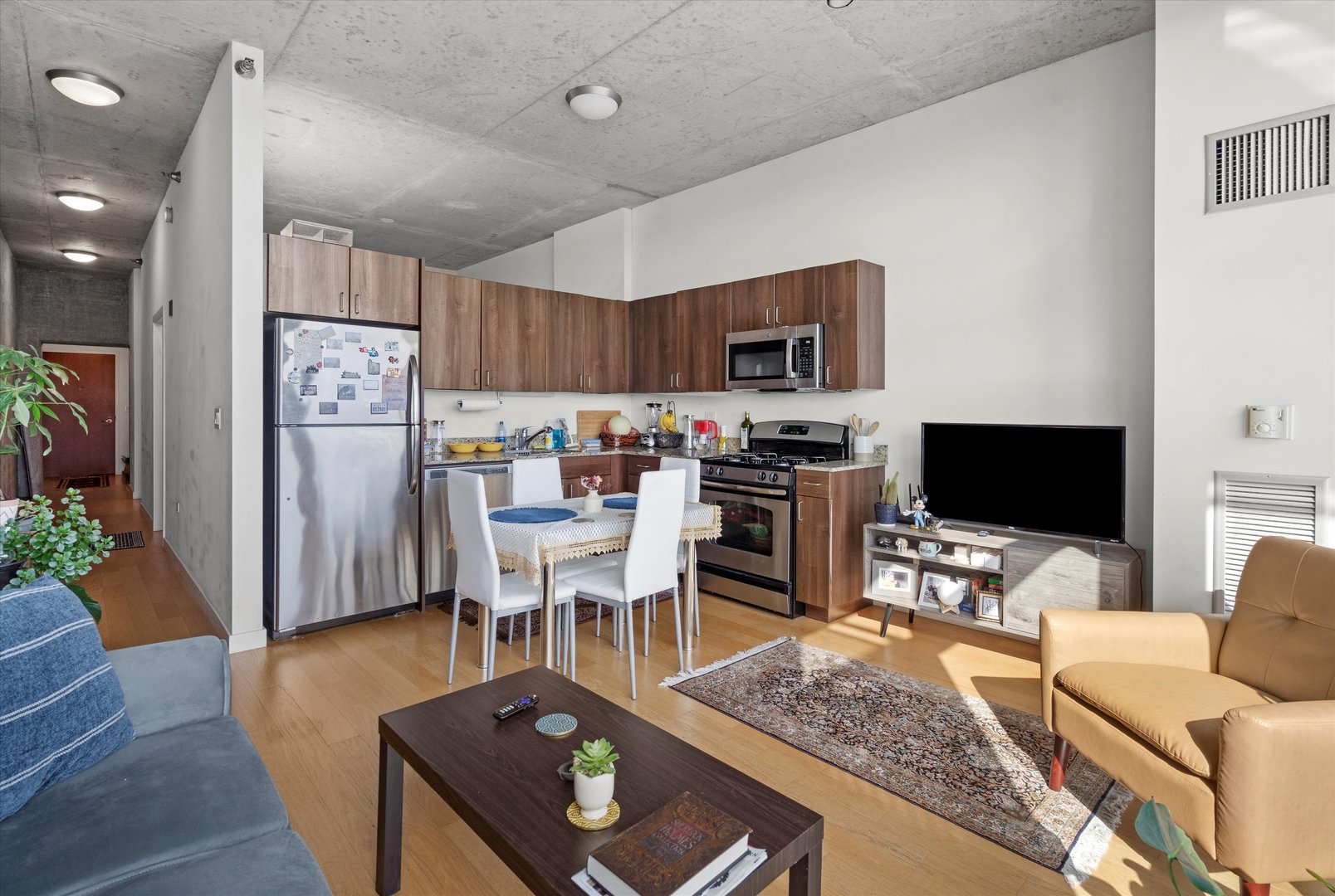 235 West Van Buren Street, Unit 3509 Chicago, IL 60607 - Photo 2 of 19 a living room with furniture and a flat screen tv