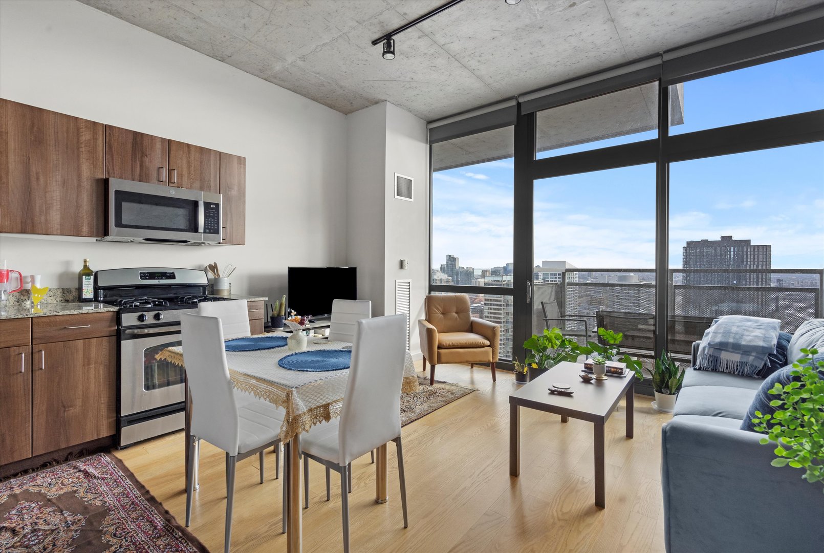235 West Van Buren Street, Unit 3509 Chicago, IL 60607 - Photo 3 of 19 a living room with furniture tv and a large window