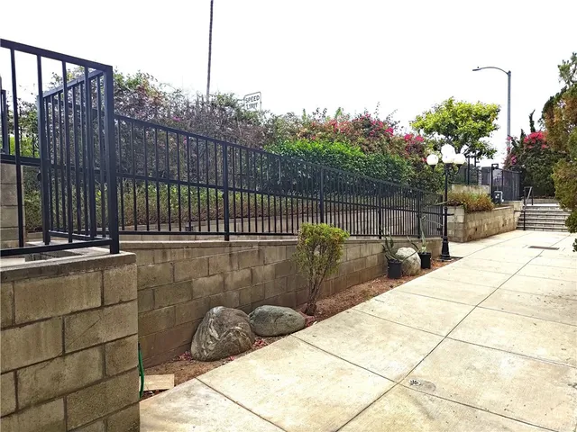 a view of balcony and wooden fence