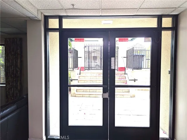 a view of a hallway with a glass door and a window