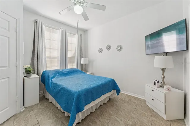 a bedroom with a bed and flat screen tv