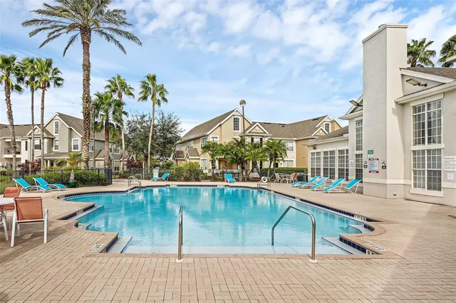 a view of a swimming pool with a lounge chairs