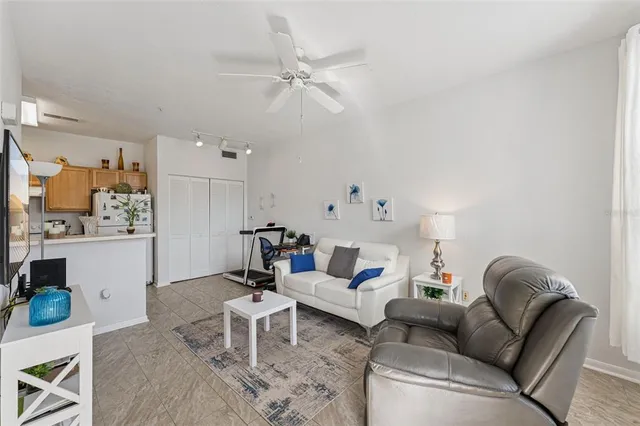 a living room with furniture and view of kitchen