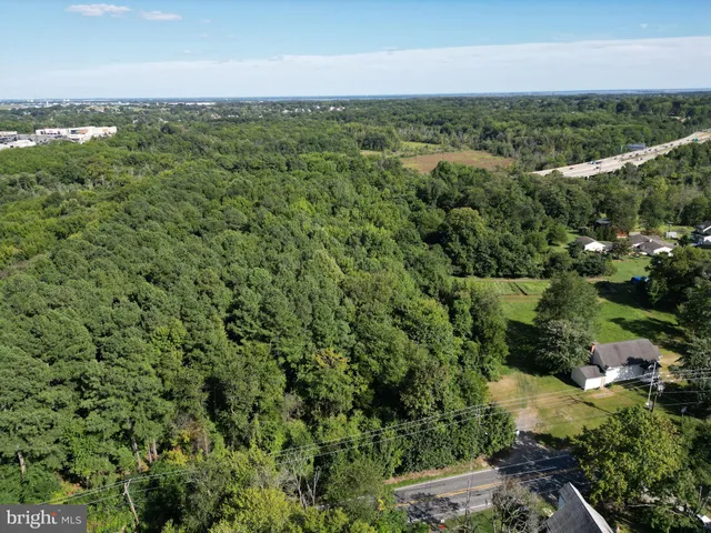 an aerial view of ocean with residential house and outdoor space