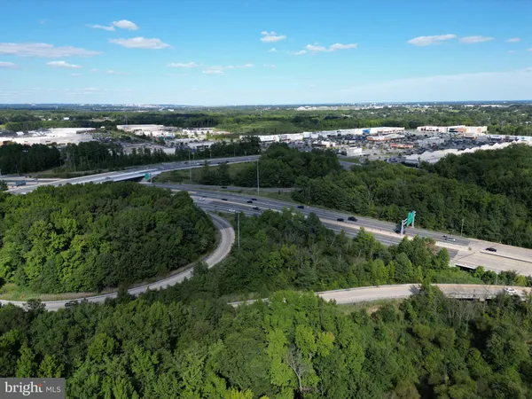 a view of a city with lush green forest