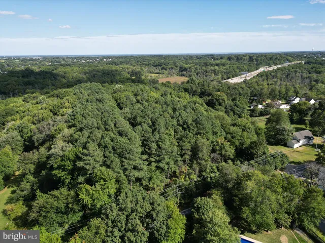 a backyard of a house with lots of green space and fountain