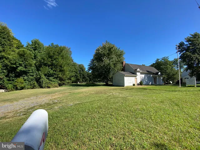 a yellow house with trees in front of it