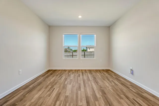 a view of room with window and hardwood floor