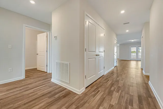 a view of hallway with wooden floor