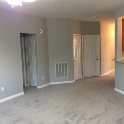 a view of an empty room and a window