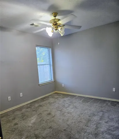 a view of room with window and ceiling fan