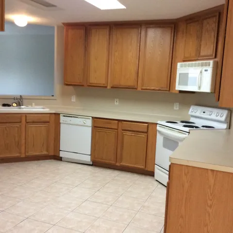 a kitchen with cabinets and white appliances