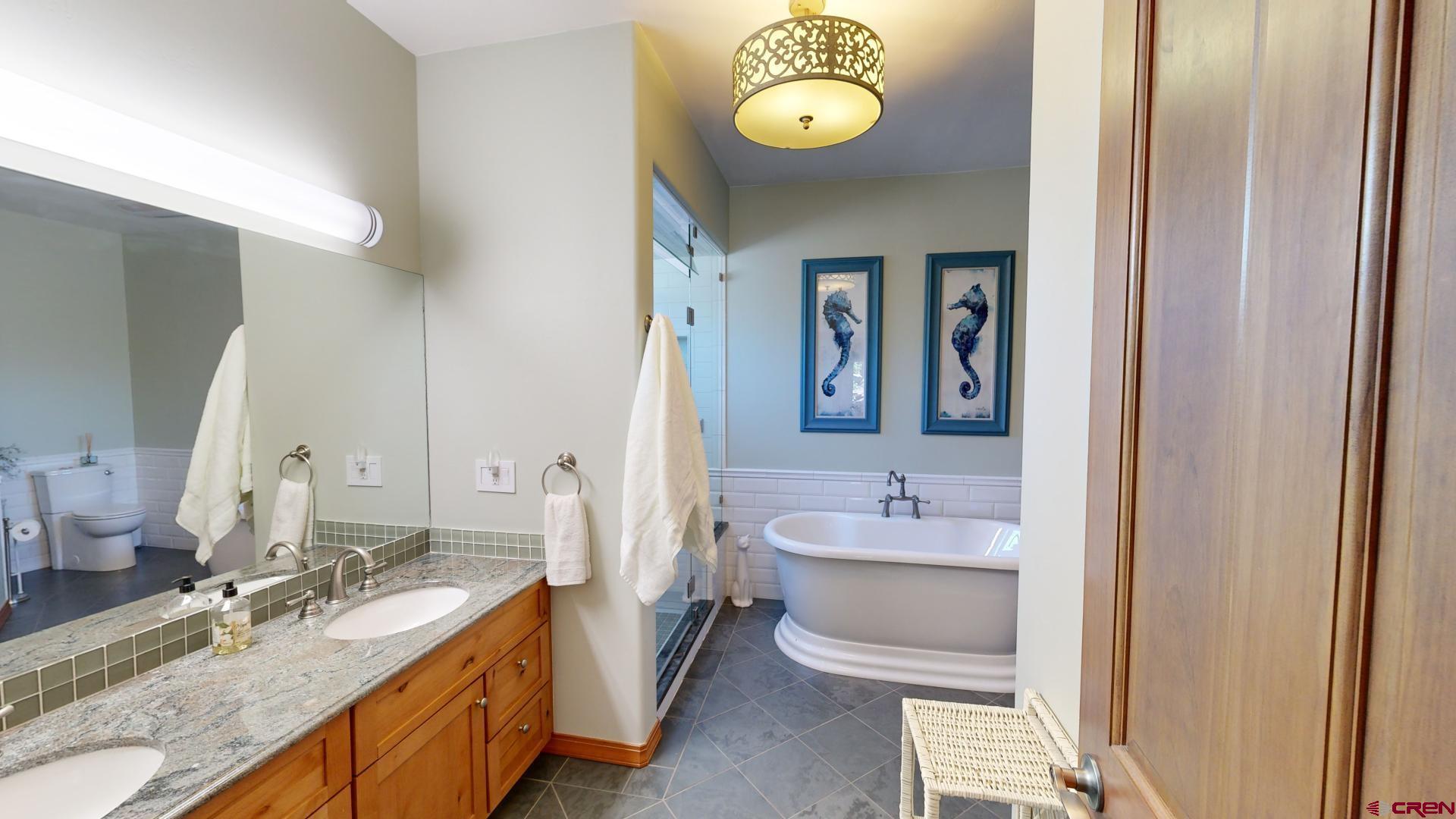 222 Jenkins Ranch Road Durango, CO 81301 - Photo 19 of 30 a bathroom with a granite countertop sink and a mirror