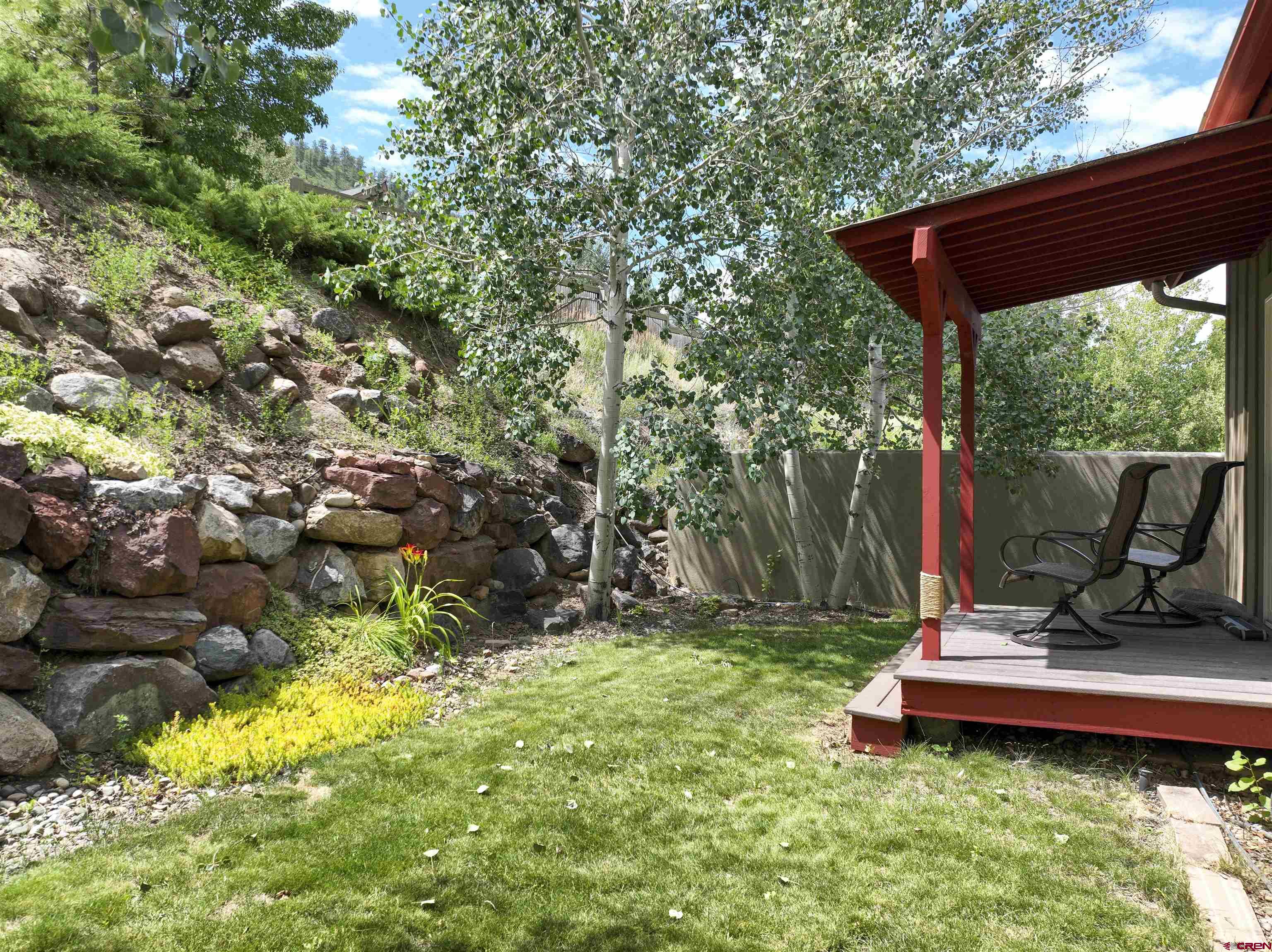 222 Jenkins Ranch Road Durango, CO 81301 - Photo 3 of 30 a view of a backyard with chairs and a garden
