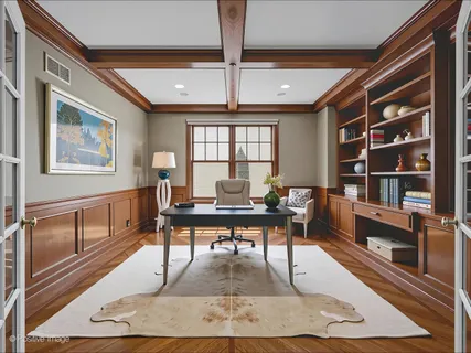 a living room with furniture a rug potted plant and a window