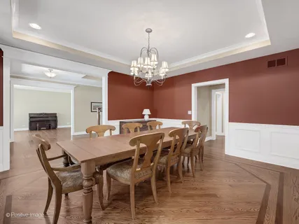 a view of a dining room with furniture and chandelier