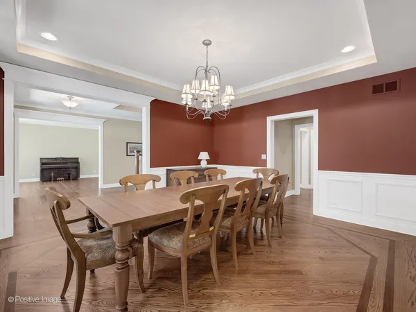 a view of a dining room with furniture and chandelier