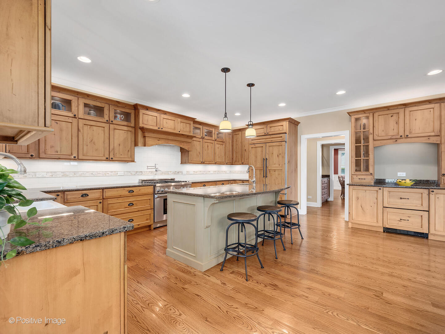 610 Washington Street Elmhurst, IL 60126 - Photo 22 of 48 a kitchen with stainless steel appliances kitchen island granite countertop a sink a stove a dining table and chairs