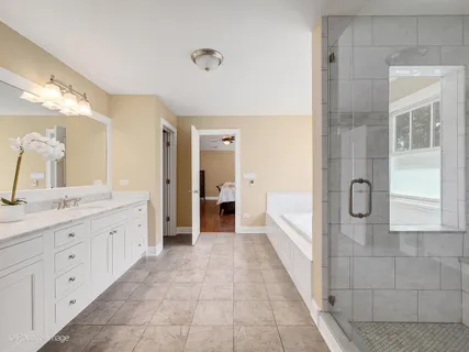 a bathroom with a granite countertop sink a mirror and a bathtub