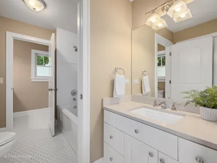 a bathroom with a sink vanity granite and a mirror