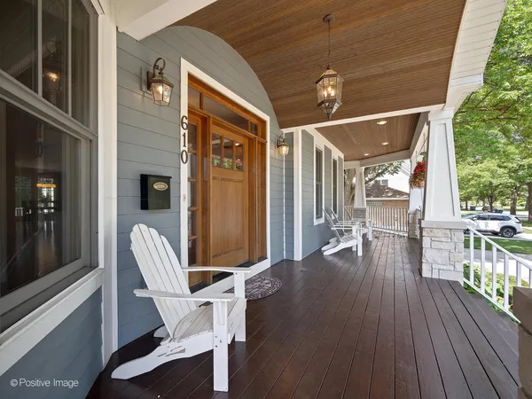 a view of a patio with table and chairs and wooden floor
