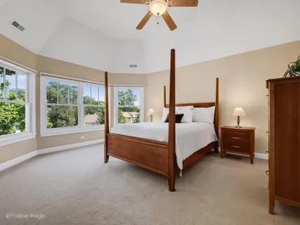 a bedroom with a bed and large window