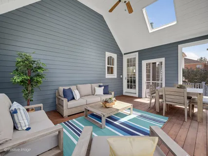 a outdoor living room with furniture and a potted plant
