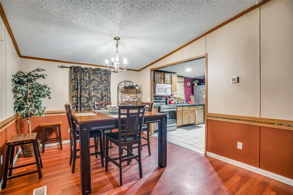 458 County Road 2131 Valley View, TX 76272 - Photo 5 of 13 Dining area adjacent to the kitchen, showcasing a seamless flow between the two spaces—perfect for entertaining and everyday living
