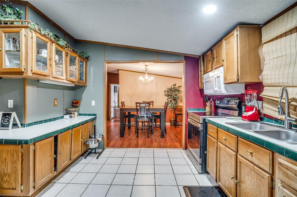 458 County Road 2131 Valley View, TX 76272 - Photo 7 of 13 View of the kitchen emphasizing extra storage and prep space, with an open flow directly into the dining room.