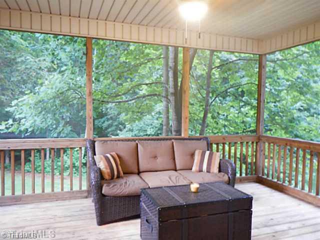 7807 Wilson Farm Road Summerfield, NC 27358 - Photo 2 of 16 Exterior Front. Relaxing screened porch with nice partially wooded lot.