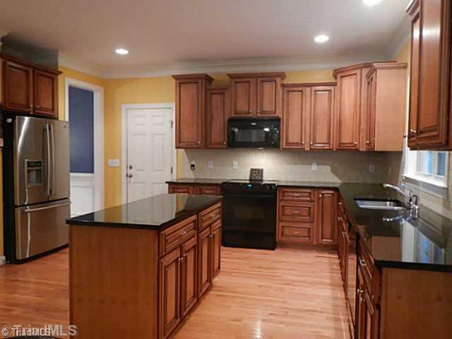7807 Wilson Farm Road Summerfield, NC 27358 - Photo 5 of 16 Exterior Front. Large kitchen with plenty of cabinet space, granite. Open to breakfast area and Den.