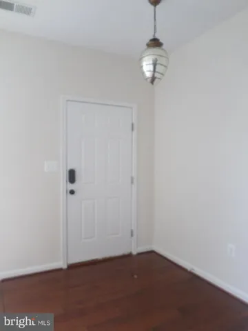 a view of a room with wooden floor