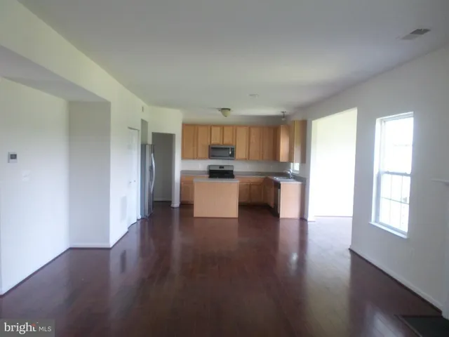 a view of kitchen with wooden floor electronic appliances and window