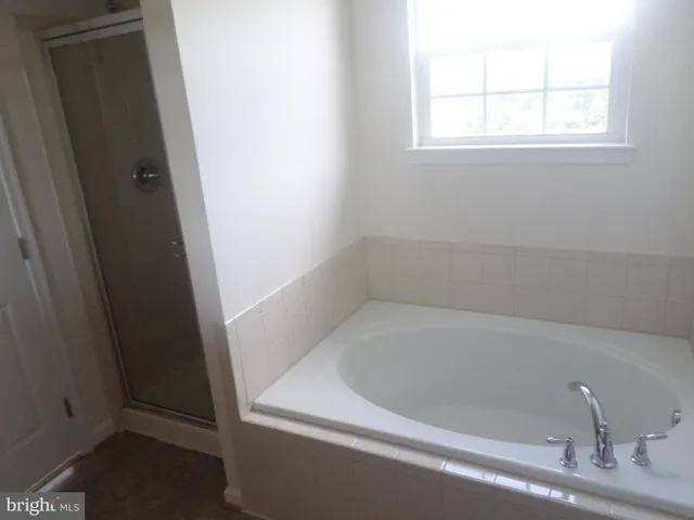 a white bath tub sitting next to a window