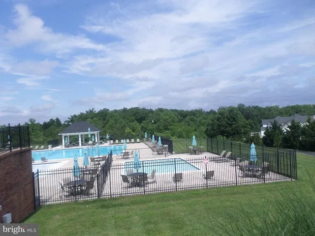a view of a chairs and table on the green field