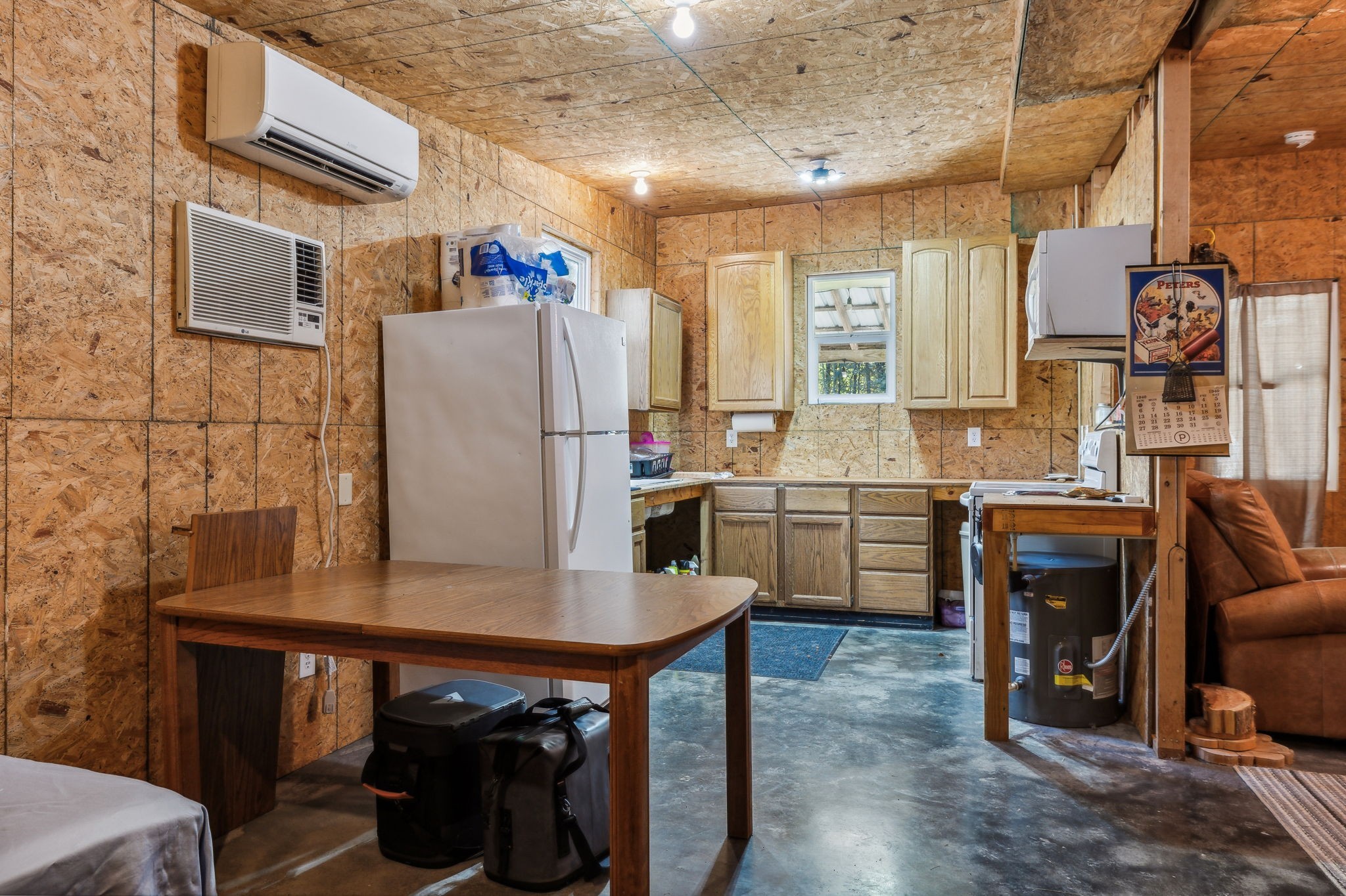 534 Whitney Branch Road Springville, TN 38256 - Photo 13 of 41 a kitchen with refrigerator and chairs