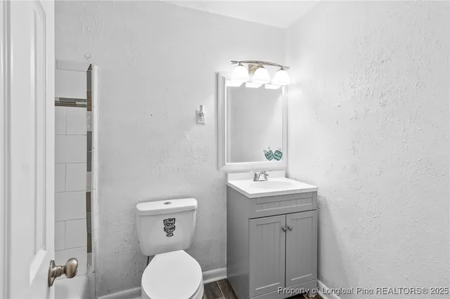 a bathroom with a toilet a sink and mirror