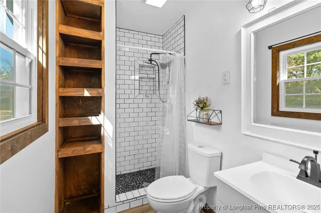 a bathroom with a toilet and a shower