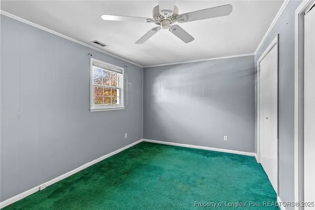 a view of room with window and ceiling fan